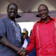 Raila Odinga, left, shakes hands with rival Uhuru Kenyatta, during a Nairobi election rally, in Feb. 2013.